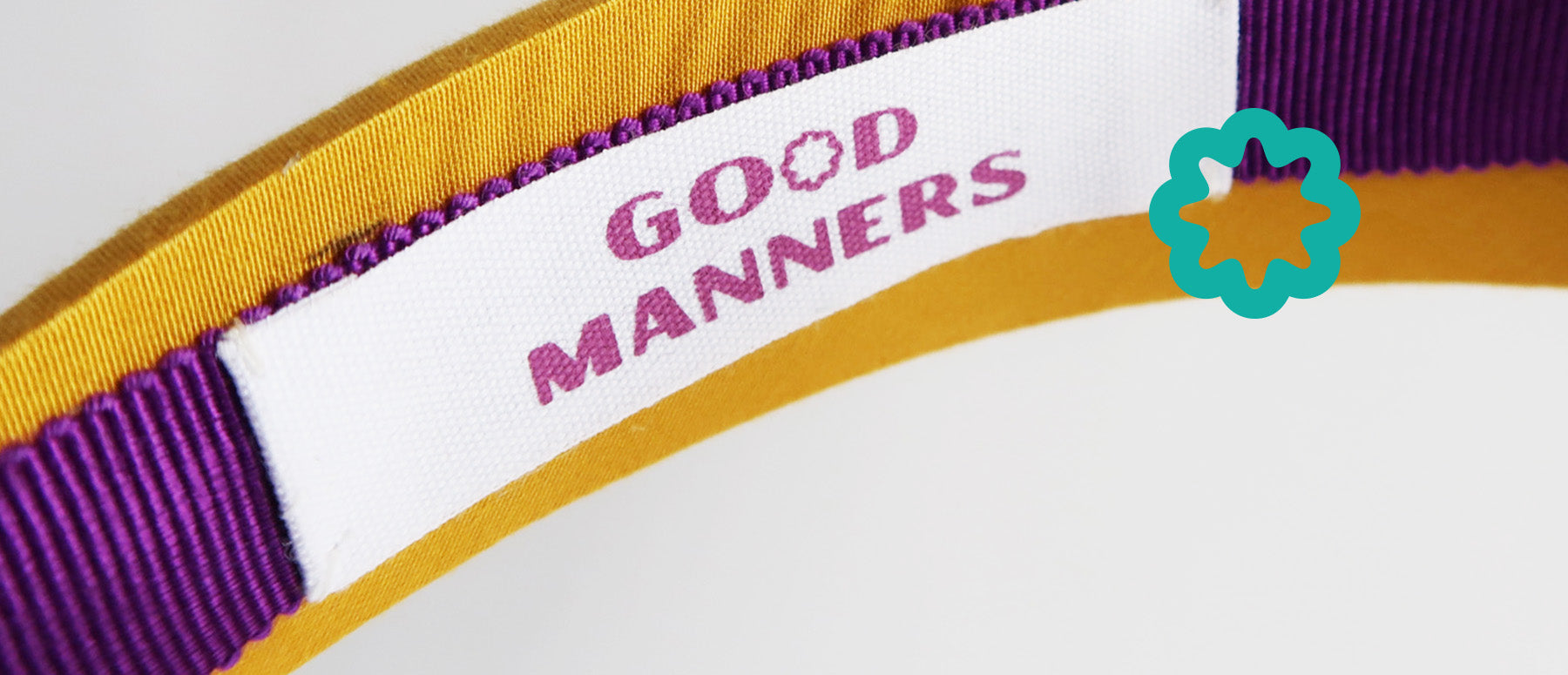 good manners style yellow headband close up of label detail